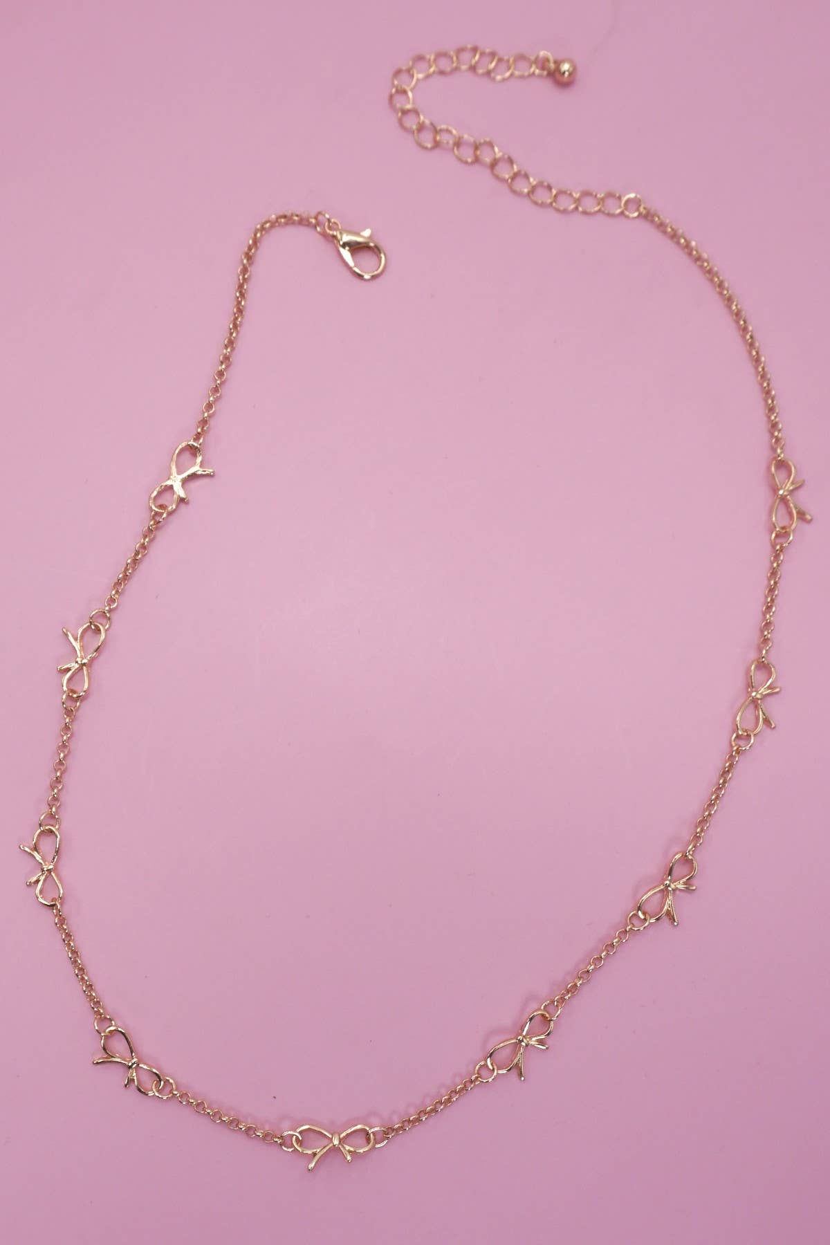 GOLD CUTOUT BOW NECKLACE
